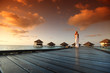 woman in a dress on maldivian sunset