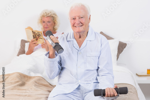 Photo: Elderly man lifting hand weights Elderly man lifting hand weights