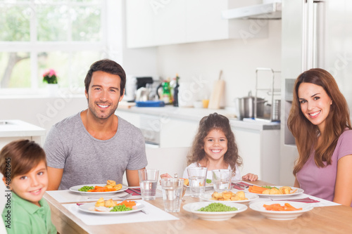 Photo: Smiling family having dinner Smiling family having dinner