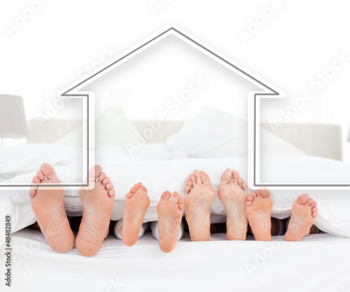 Photo: Feet family in the duvet with house illustration Feet family in the duvet with house illustration