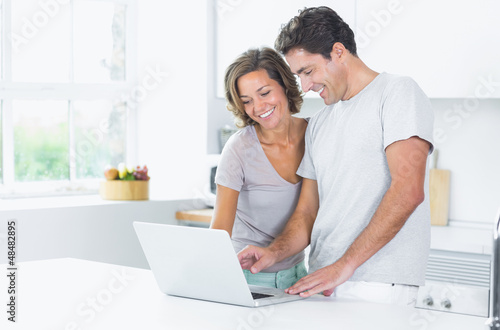 Photo: Couple looking at laptop Couple looking at laptop
