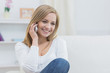 Photo: Casual young woman using mobile phone at home Casual young woman using mobile phone at home