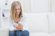 Happy woman with mobile phone at home