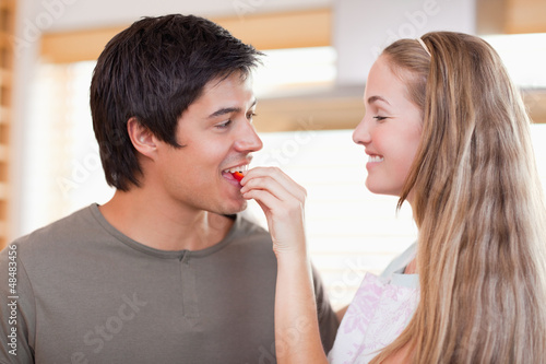 Photo: Woman feeding vegetable to man Woman feeding vegetable to man