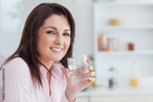 Photo: Close-up portrait of woman with glass of water Close-up portrait of woman with glass of water