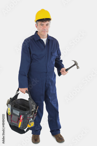 Photo: Mature mechanic carrying tool bag Mature mechanic carrying tool bag