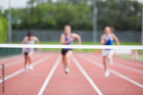 Photo: Athletes running towards finish line Athletes running towards finish line