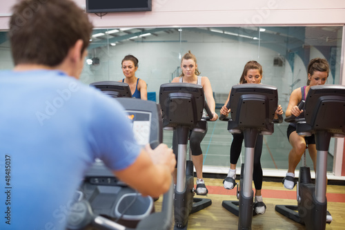 Photo: Man instructs spinning class Man instructs spinning class