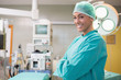 Photo: Happy surgeon crossing her arms in an operation room Happy surgeon crossing her arms in an operation room