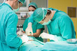 Surgeons working with a scissors on a patient