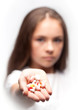 Photo: Close up of girl is holding pills Close up of girl is holding pills