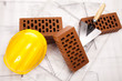 Building house, trowel and bricks