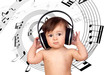 Adorable baby girl with big headphones