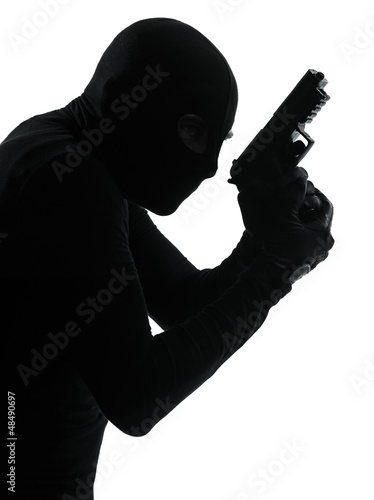 Photo: thief criminal terrorist holding gun portrait thief criminal terrorist holding gun portrait
