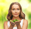 woman with spinach leaves on palms