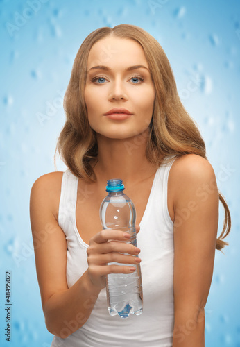 Photo: young beautiful woman with bottle of water young beautiful woman with bottle of water