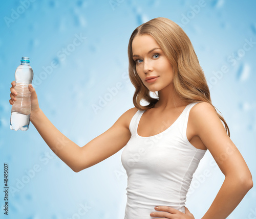 Photo: young beautiful woman with bottle of water young beautiful woman with bottle of water