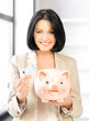 lovely woman with piggy bank and money