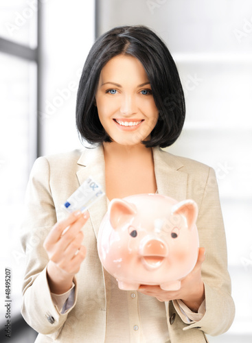 Photo: lovely woman with piggy bank and money lovely woman with piggy bank and money