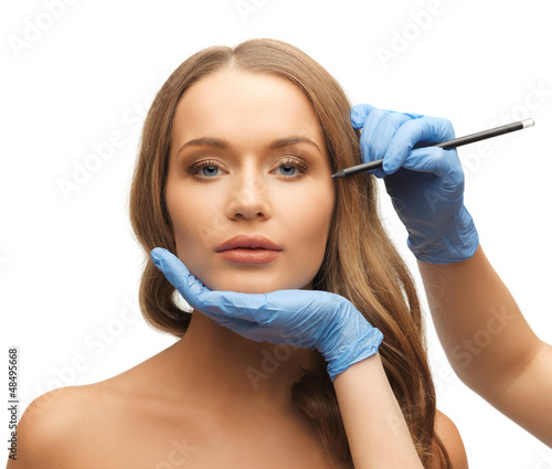 Photo: woman face and beautician hands woman face and beautician hands