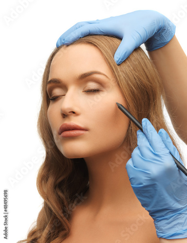 Photo: woman face and beautician hands woman face and beautician hands