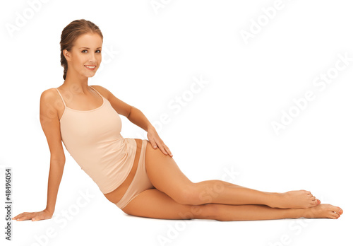 Photo: woman in cotton underwear touching her legs woman in cotton underwear touching her legs