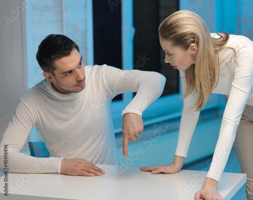 Photo: man and woman working with something man and woman working with something