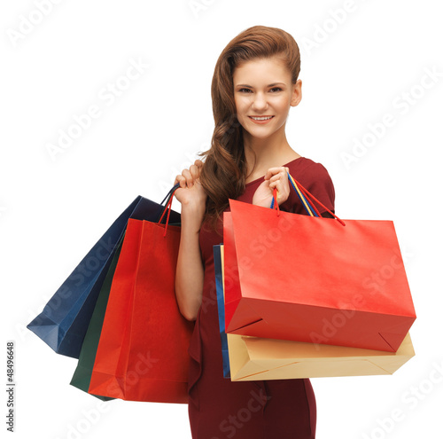 Photo: teenage girl in red dress with shopping bags teenage girl in red dress with shopping bags
