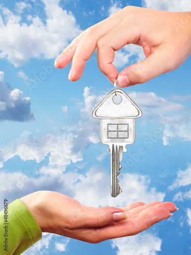 Photo: Hand with a home key. Hand with a home key.