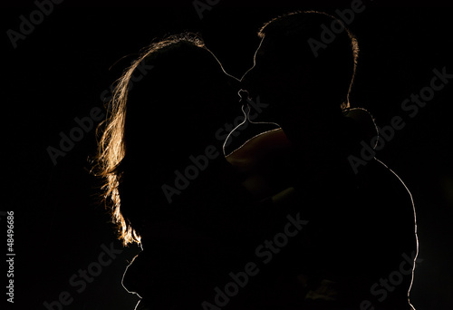 Photo: Silhouette of a young couple in the dark Silhouette of a young couple in the dark
