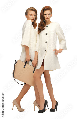 Photo: two teenage girls in white coats with bag two teenage girls in white coats with bag
