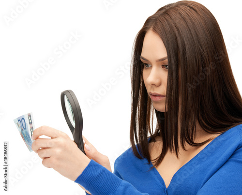 Photo: woman with magnifying glass and euro cash money woman with magnifying glass and euro cash money