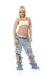 Portrait of athletic blonde girl in lingerie and high torn jeans