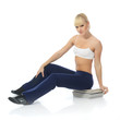 Athletic girl doing fitness exercises with a stack of magazines