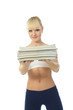 Athletic girl doing fitness exercises with a stack of magazines
