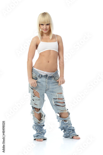 Photo: Portrait of athletic blonde girl in lingerie and high torn jeans Portrait of athletic blonde girl in lingerie and high torn jeans