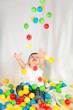 Photo: Cute boy playing colorful balls Cute boy playing colorful balls