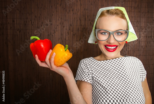 Photo: Funny woman cook holading sweet pepper, close up Funny woman cook holading sweet pepper, close up