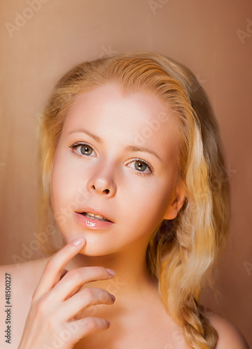 Photo: Portrait of Pretty Young Woman Blonde touching her Fresh Face Portrait of Pretty Young Woman Blonde touching her Fresh Face
