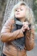 Blonde young woman holding hands, at the woods