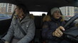 Woman a driver driving car with male passenger near. Timelapse