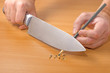 sharpening a pencil with a knife on desk background