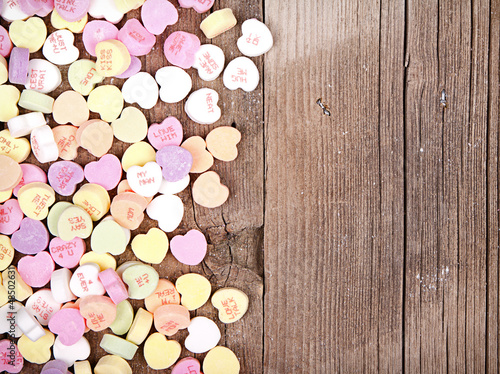 Photo: heart shape candy on wooden plank heart shape candy on wooden plank