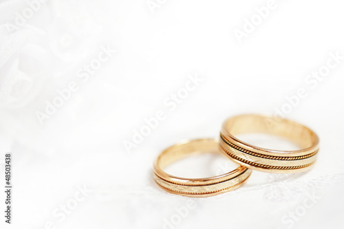 Photo: Two golden wedding rings with seamless flower decorations Two golden wedding rings with seamless flower decorations