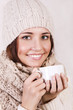 Winter girl drinking warm beverage.