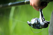 Fisherman holding rod (reel) Catch trench, crucian, bremes etc