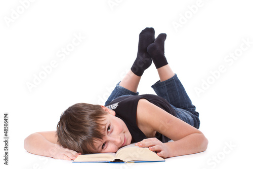 Photo: boy reading a book on white background boy reading a book on white background