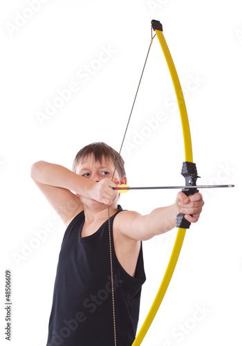 Photo: boy shoots a bow on a white background boy shoots a bow on a white background
