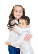 Little girl and boy hugging. Isolated on white