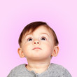 Surprised baby girl looking up